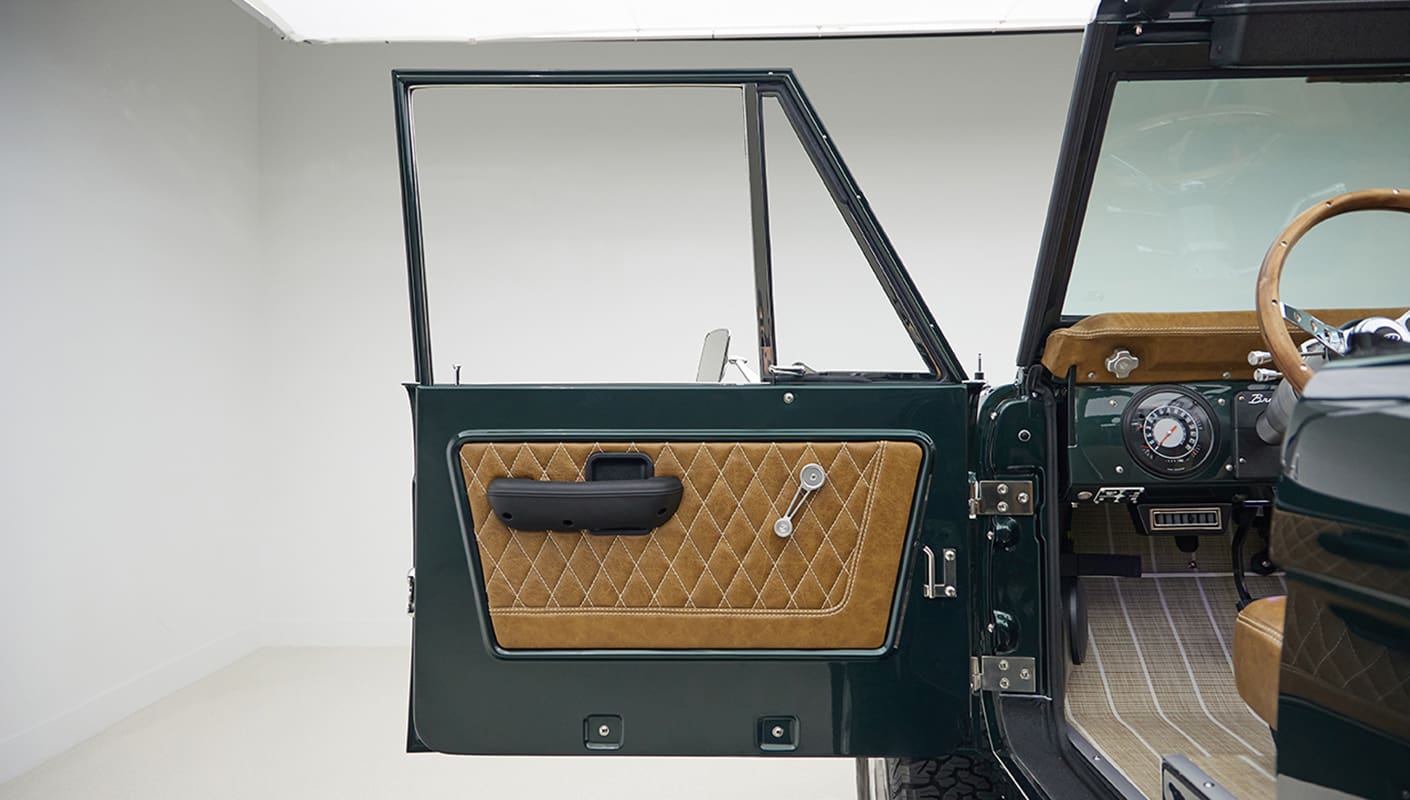 1966 ford bronco in highland green with whiskey leather interior door panel