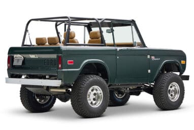 1966 ford bronco in highland green with whiskey leather interior rear passenger angle