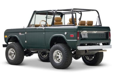 1966 ford bronco in highland green with whiskey leather interior rear driver angle