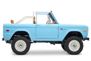 1973 Classic Ford Bronco in frozen blue with rolls royce orange leather and alpaca interior passenger profile