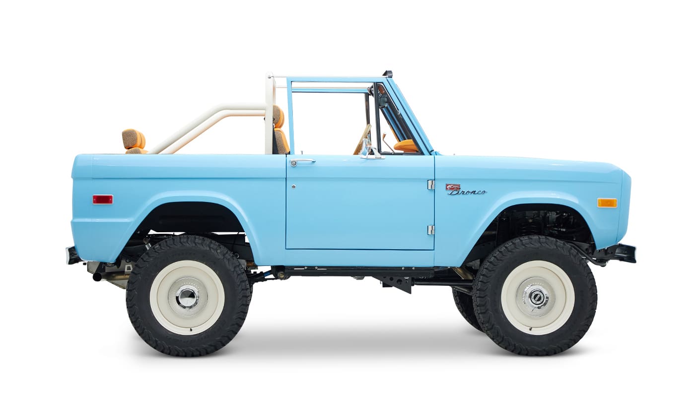 1973 Classic Ford Bronco in frozen blue with rolls royce orange leather and alpaca interior passenger profile