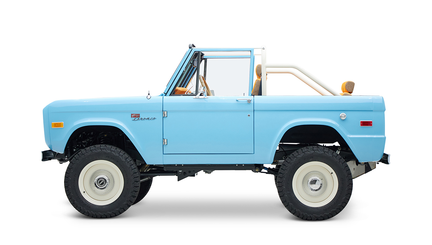 1973 Classic Ford Bronco in frozen blue with rolls royce orange leather and alpaca interior driver profile