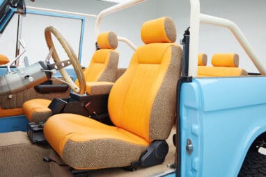 1973 Classic Ford Bronco in frozen blue with rolls royce orange leather and alpaca interior driver seat