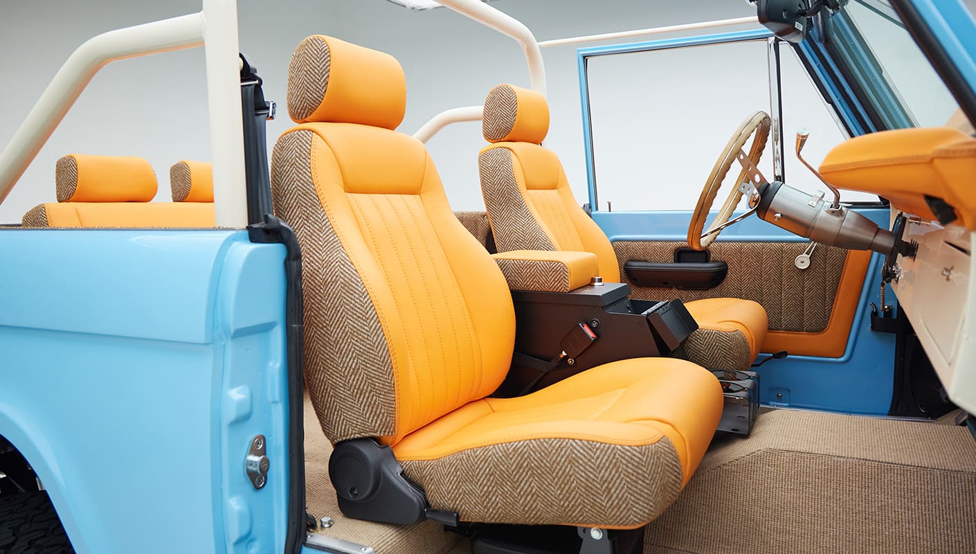 1973 Classic Ford Bronco in frozen blue with rolls royce orange leather and alpaca interior passenger seat