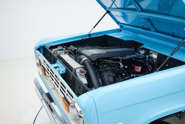 1973 Classic Ford Bronco in frozen blue with rolls royce orange leather and alpaca interior motor angle