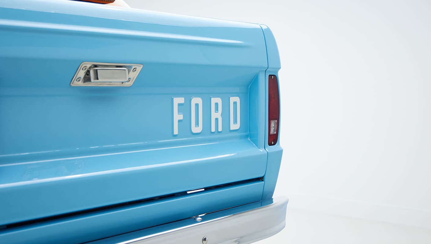 1973 Classic Ford Bronco in frozen blue with rolls royce orange leather and alpaca interior emblem
