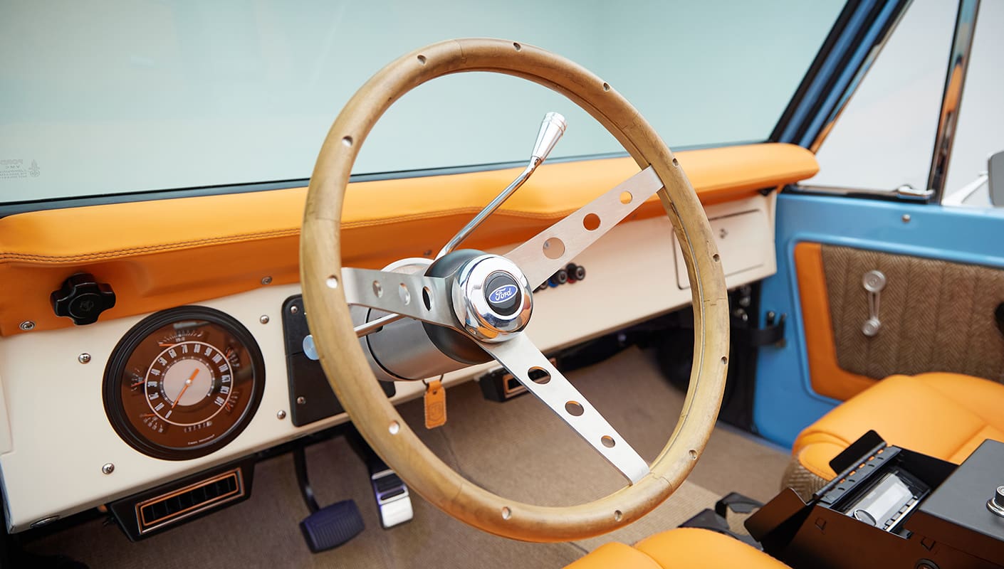 1973 Classic Ford Bronco in frozen blue with rolls royce orange leather and alpaca interior steering wheel