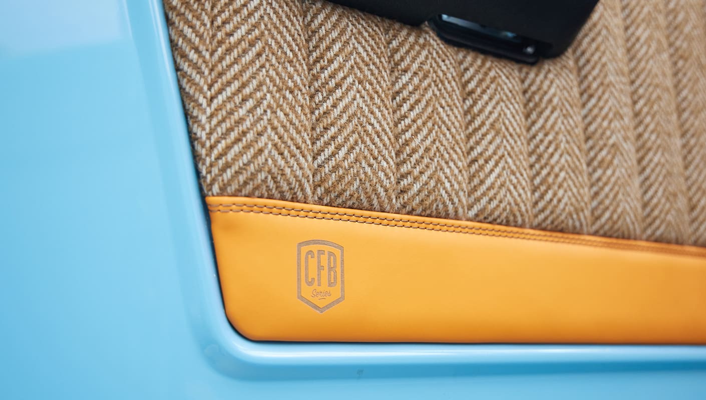 1973 Classic Ford Bronco in frozen blue with rolls royce orange leather and alpaca interior door panel