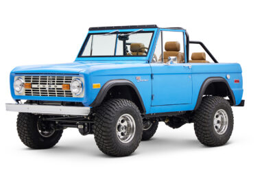 1976 classic ford bronco in blue patina paint with whiskey leather interior driver front angle