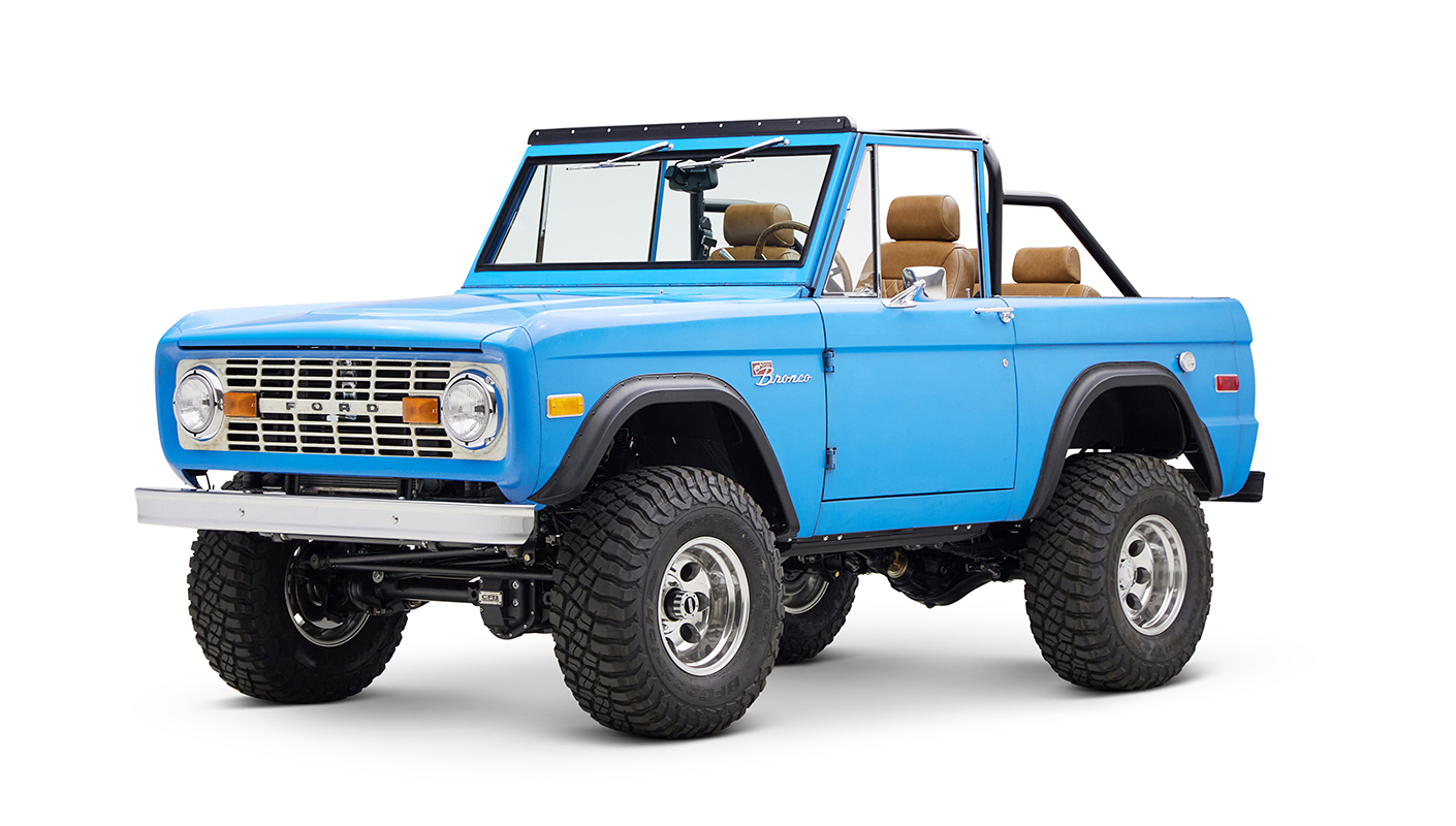 1976 classic ford bronco in blue patina paint with whiskey leather interior driver front angle