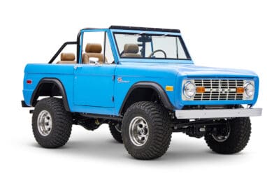 1976 classic ford bronco in blue patina paint with whiskey leather interior passenger front angle