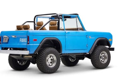 1976 classic ford bronco in blue patina paint with whiskey leather interior passenger rear angle