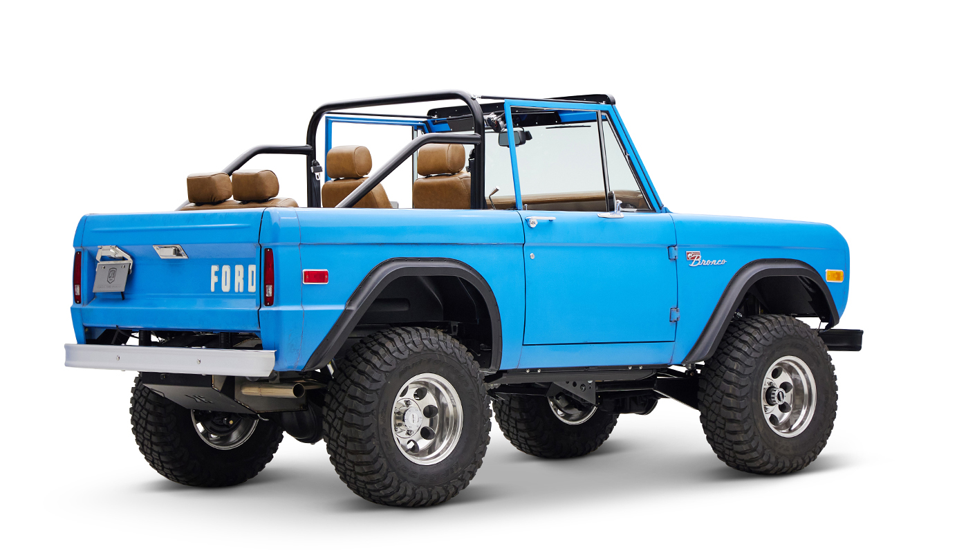 1976 classic ford bronco in blue patina paint with whiskey leather interior passenger rear angle