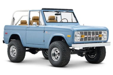 1974 classic ford bronco in stars & stripes blue with whiskey leather passenger front angle