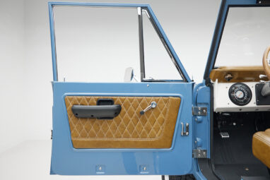 1974 classic ford bronco in stars & stripes blue with whiskey leather door panel